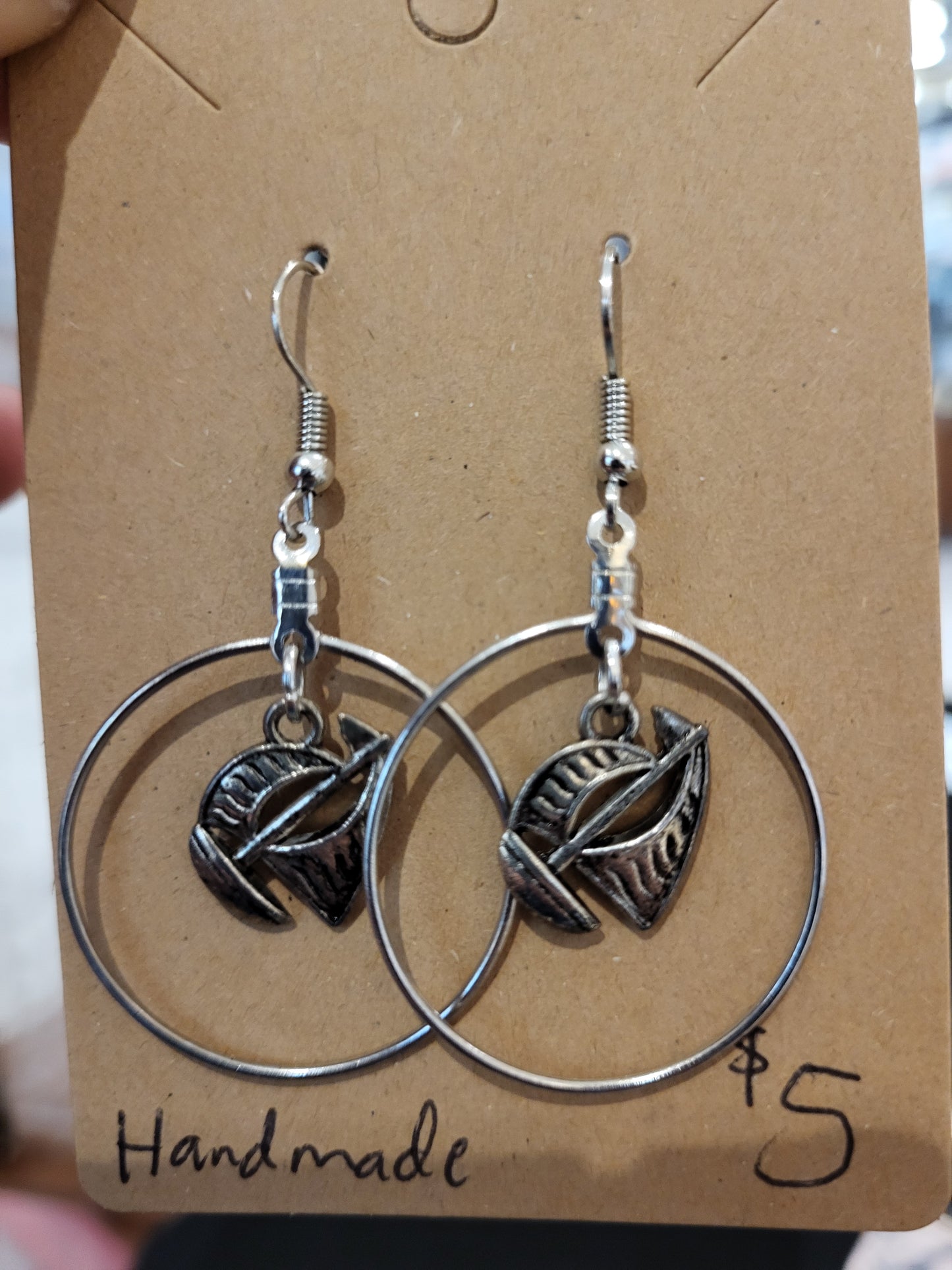 Silver sailboat within a circle earrings.