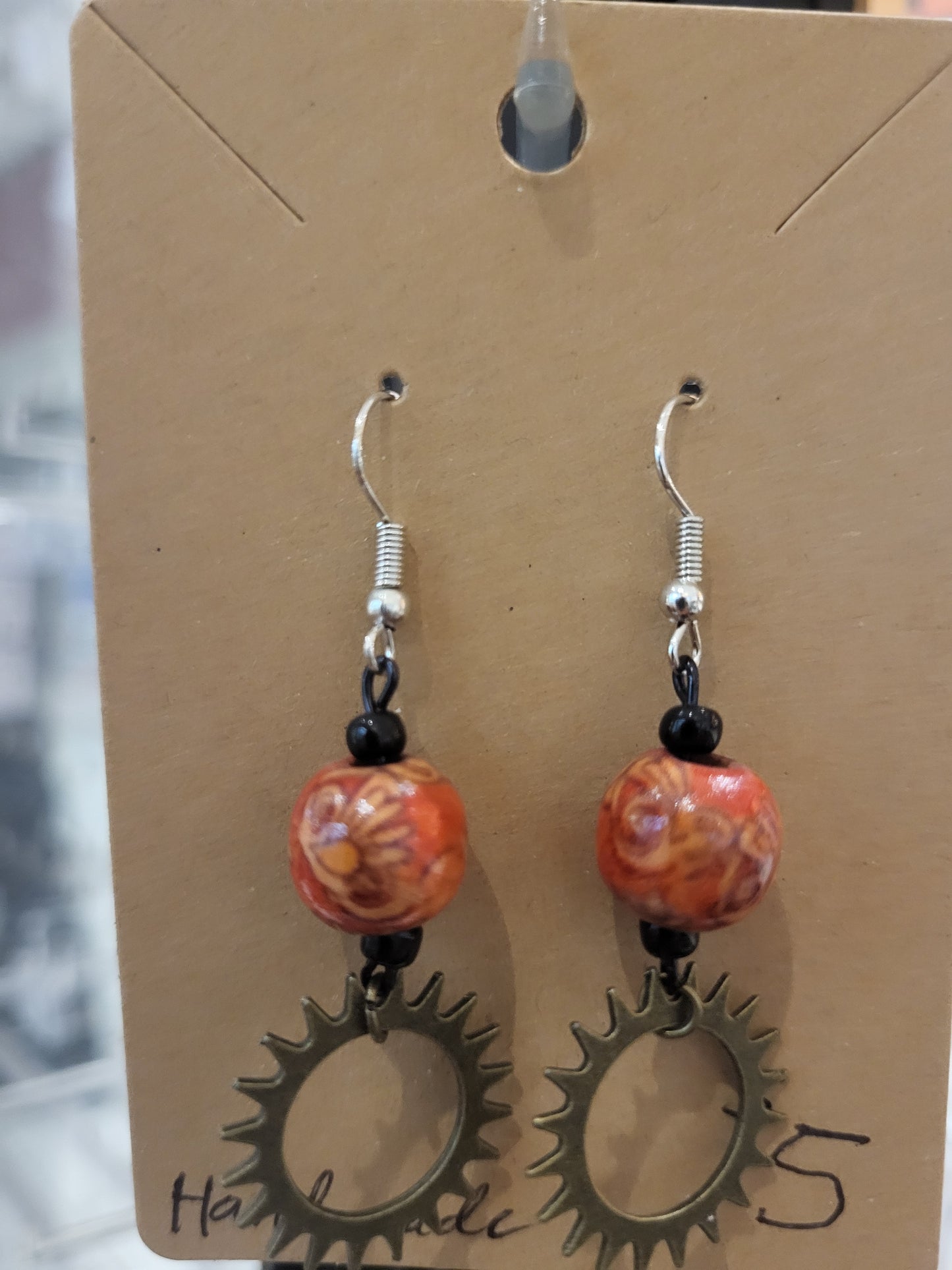 Handmade ornate red bead and sun gear earrings bottom