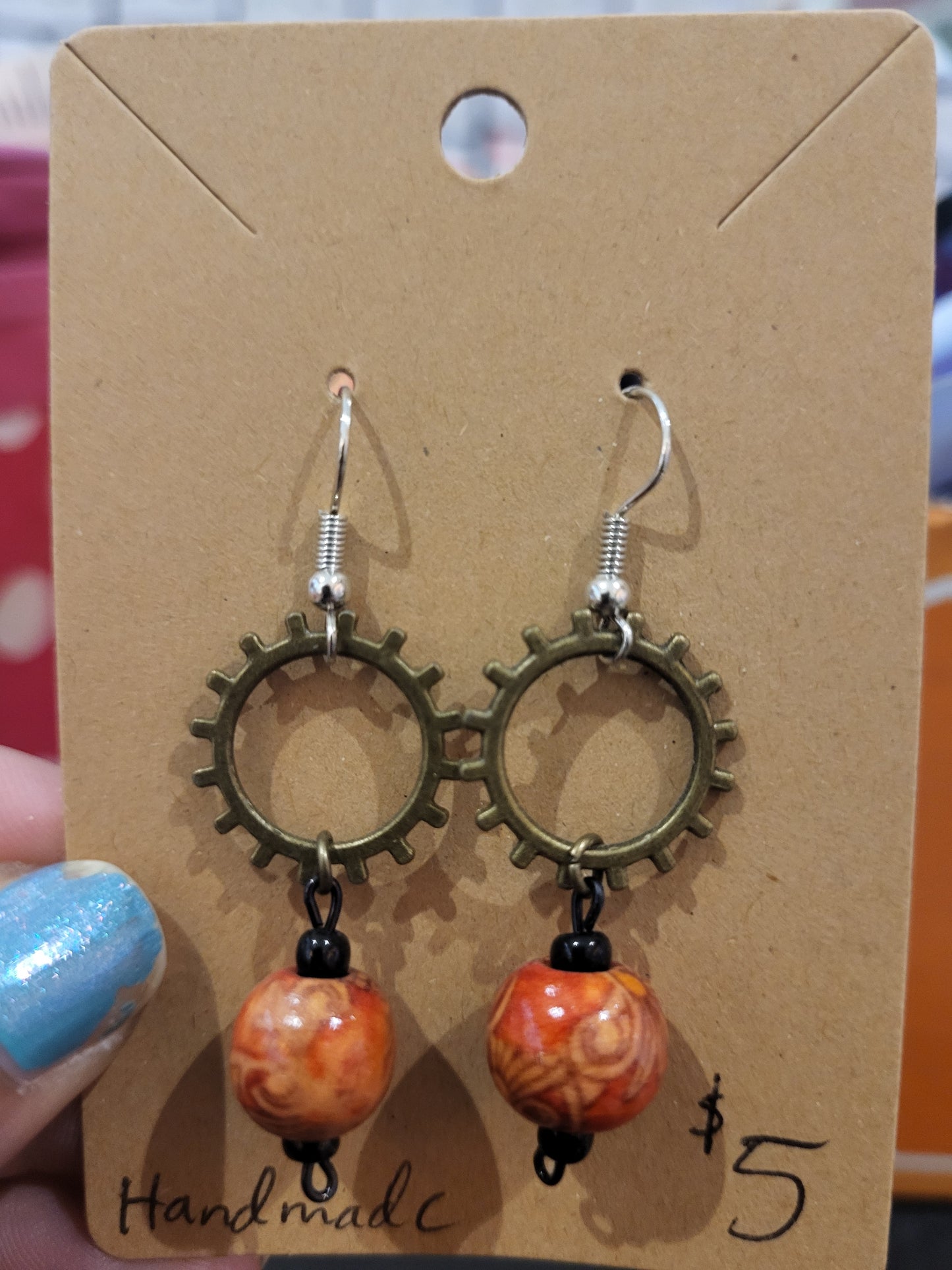 Handmade ornate red bead and sun gear earrings top alt