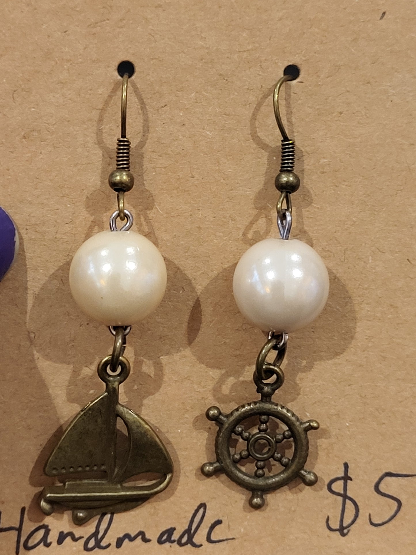 Handmade simple beige bead earrings with ship and wheel charms