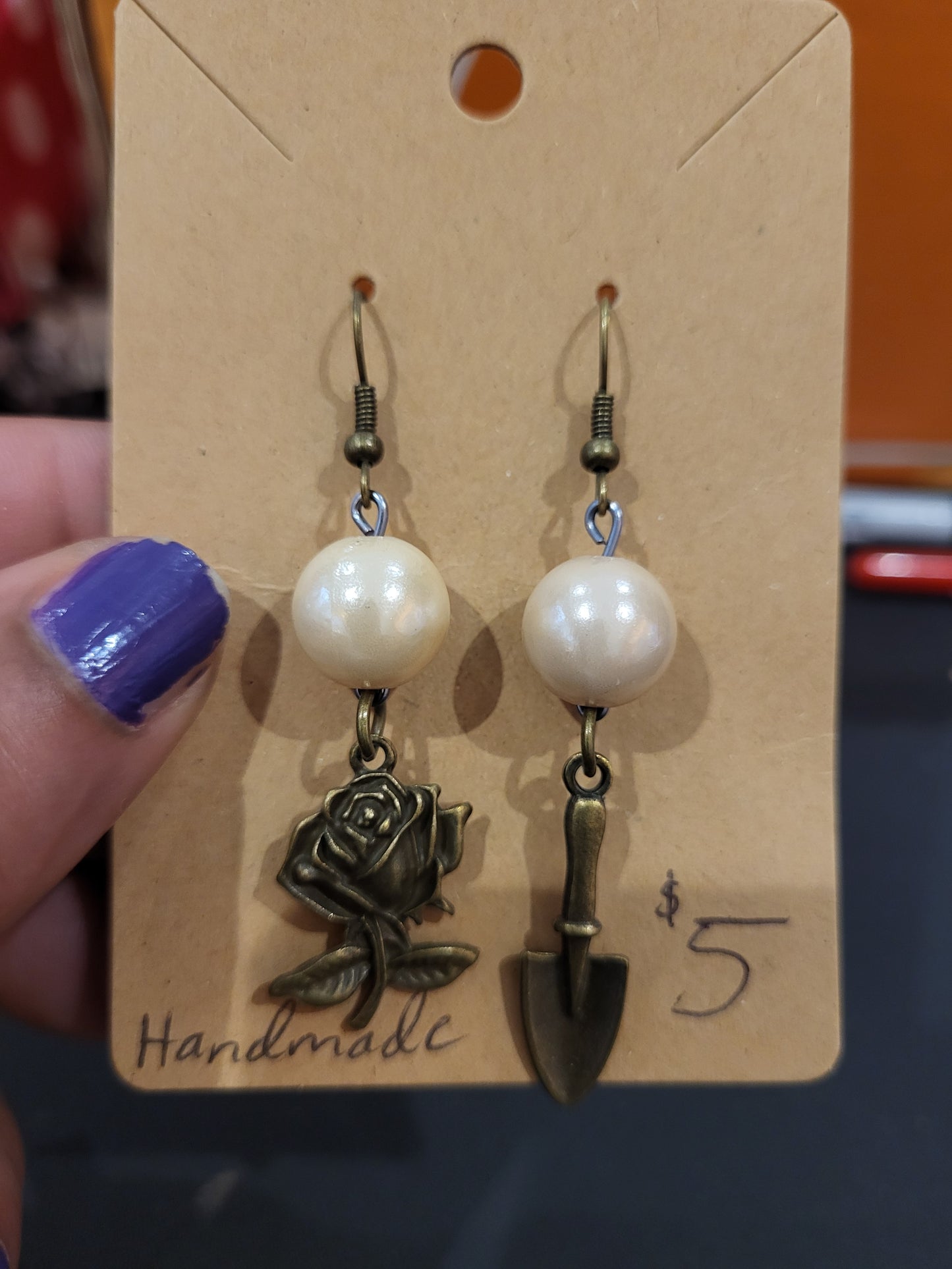 Handmade simple beige bead earrings with rose and trowel charms