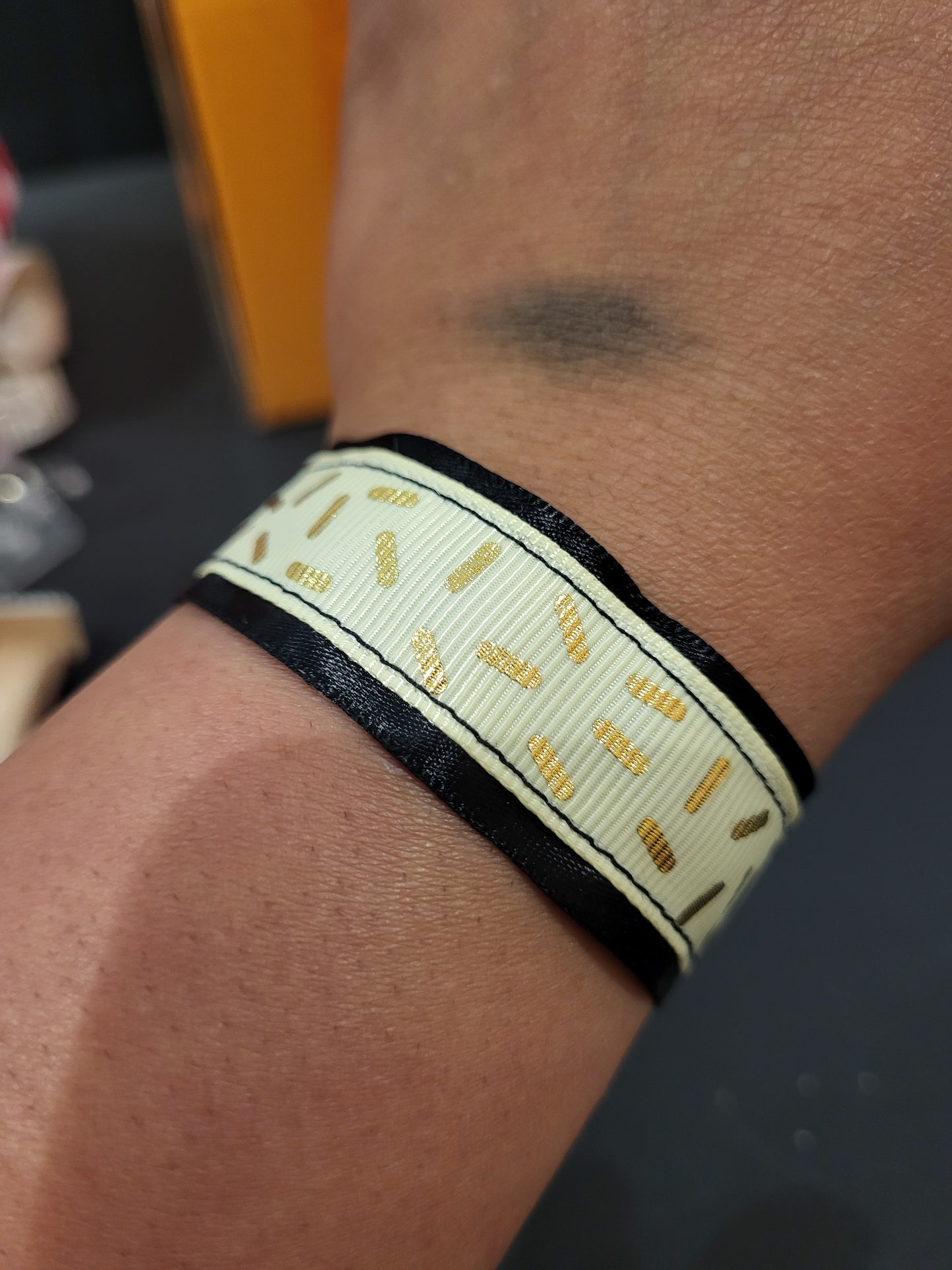 Handmade gold sprinkle fabric cuff bracelet with black ribbon backing