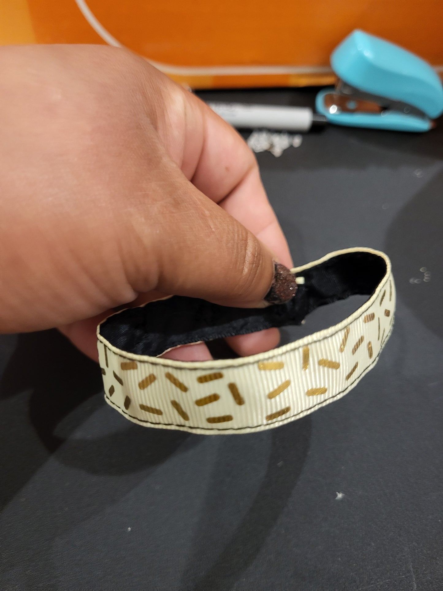 Handmade gold sprinkle fabric cuff bracelet with black ribbon backing