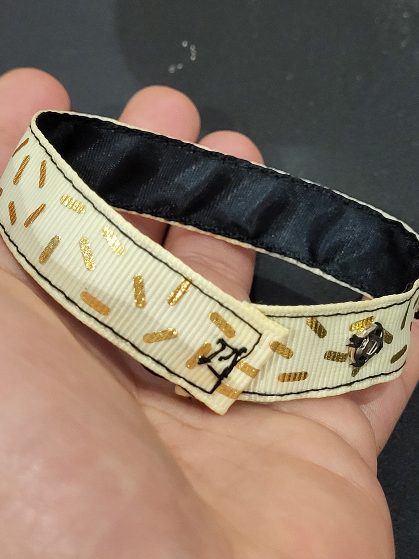 Handmade gold sprinkle fabric cuff bracelet with black ribbon backing