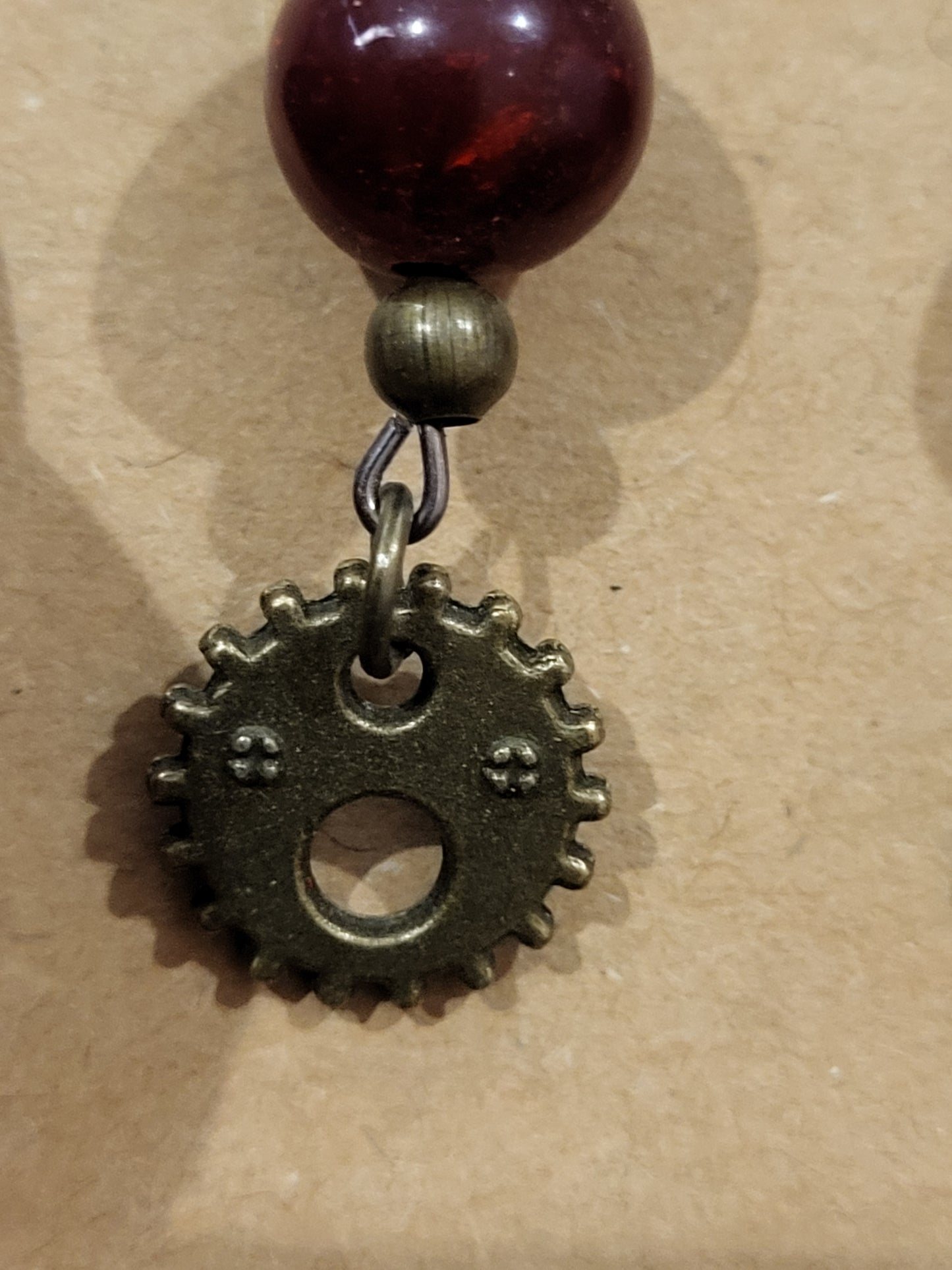 Handmade red bead and small face gear earrings