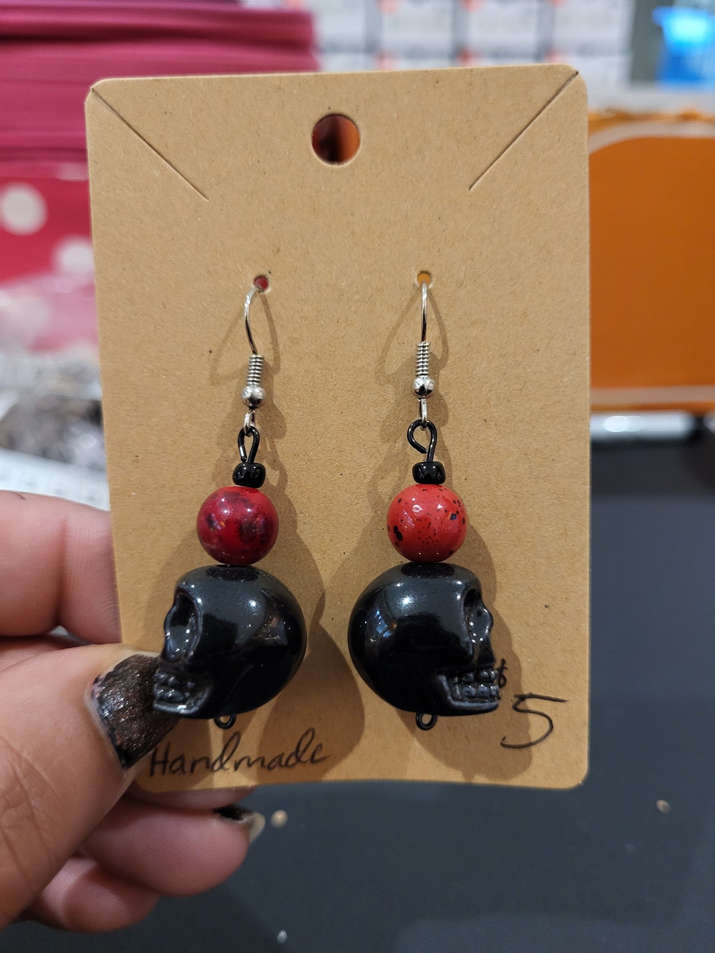 Handmade red bead and black skull earrings