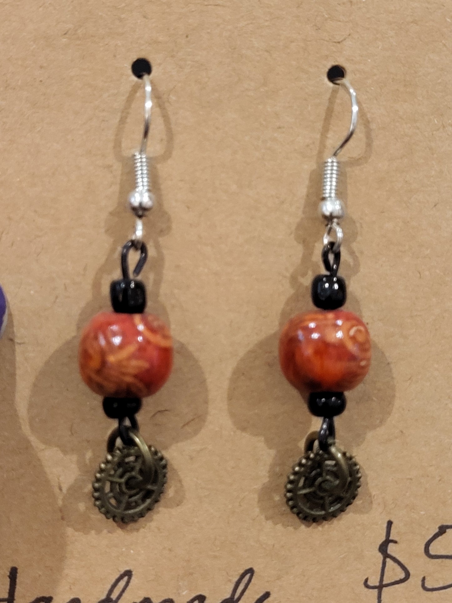 Handmade ornate red bead and mini gear earrings bottom