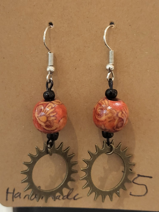 Handmade ornate red bead and sun gear earrings bottom