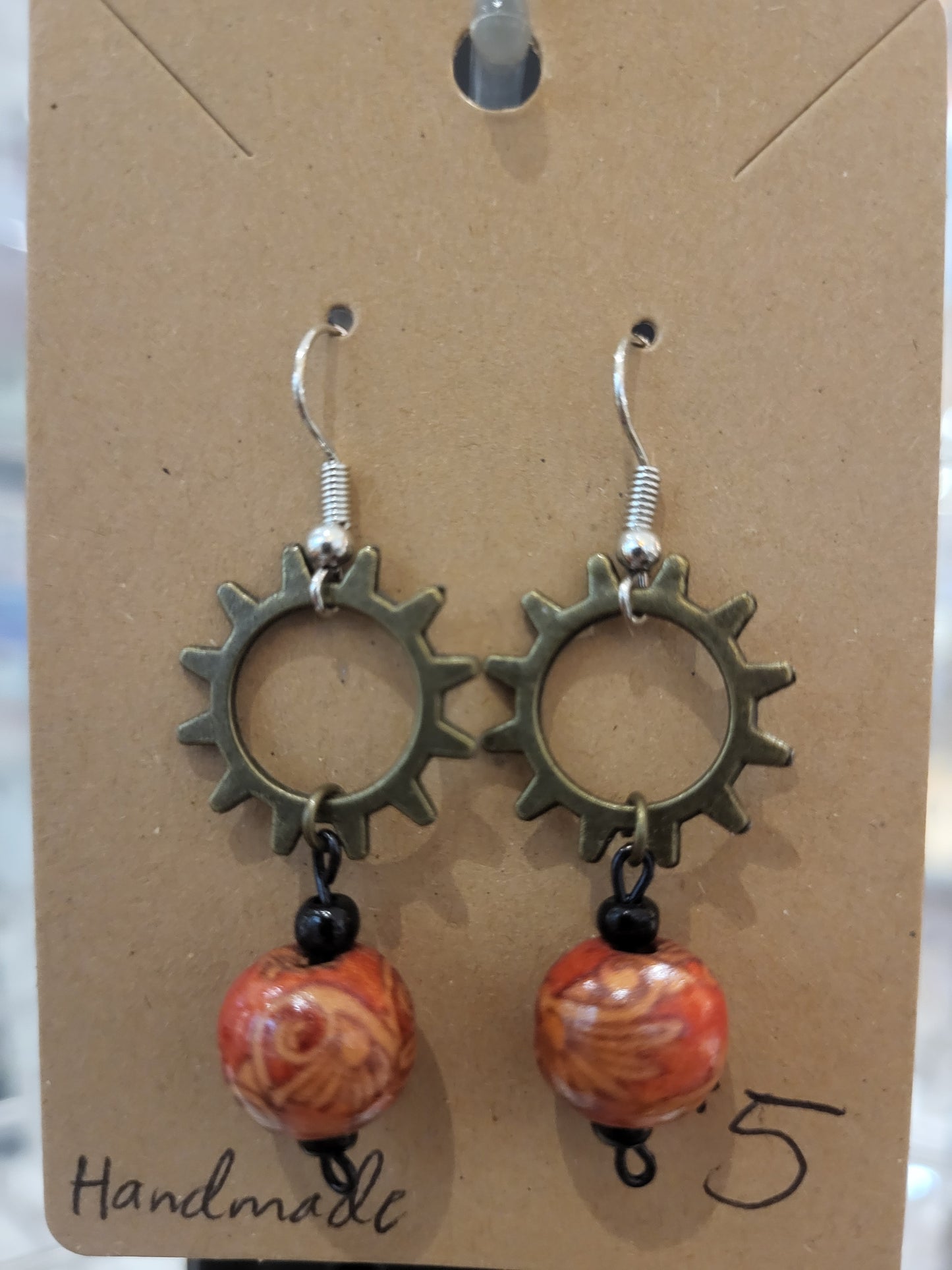 Handmade ornate red bead and sun gear earrings top