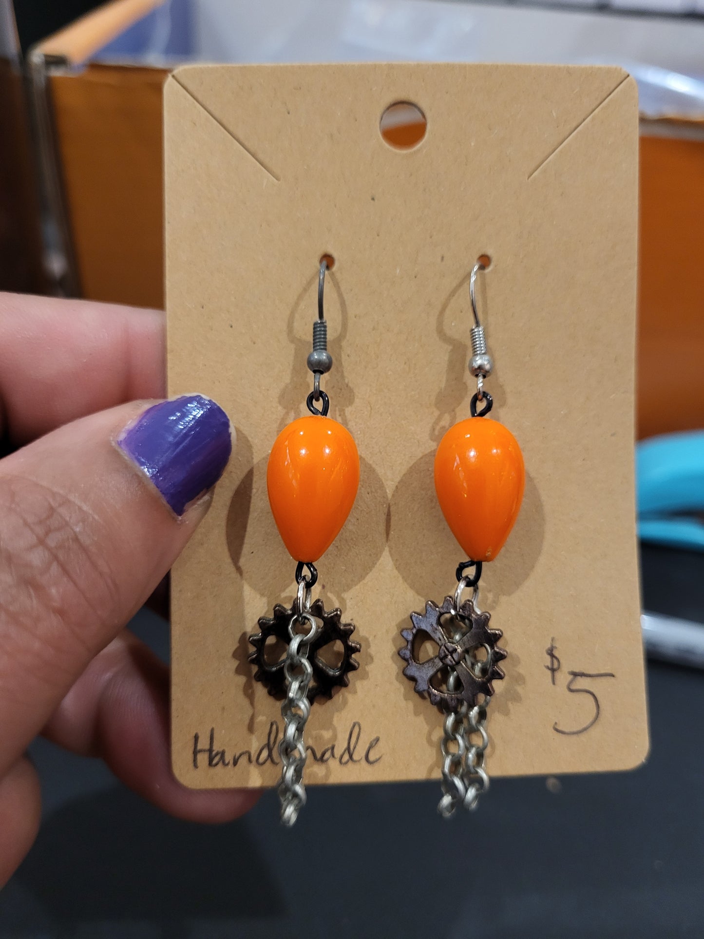 Handmade orange teardrop bead earrings with gear