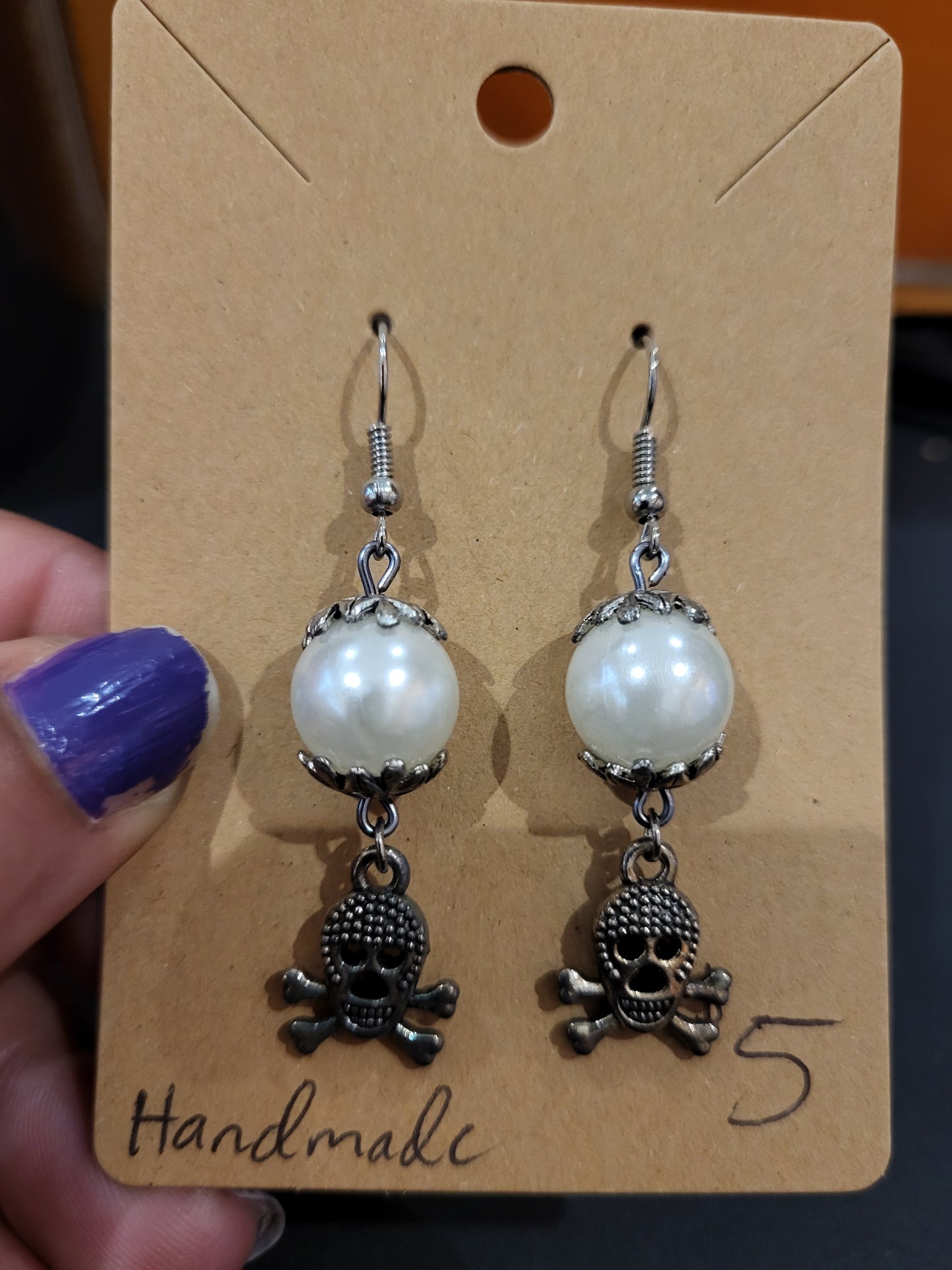 Handmade white and silver earrings with skull charm