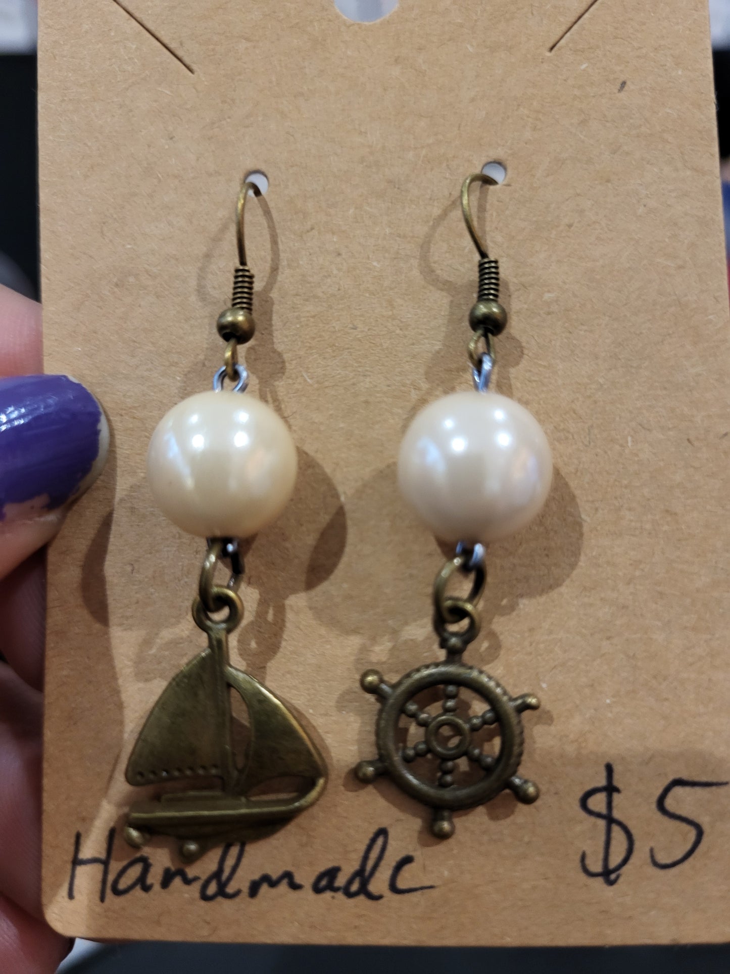 Handmade simple beige bead earrings with ship and wheel charms