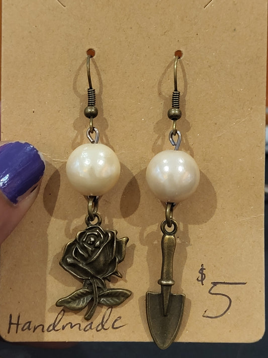 Handmade simple beige bead earrings with rose and trowel charms