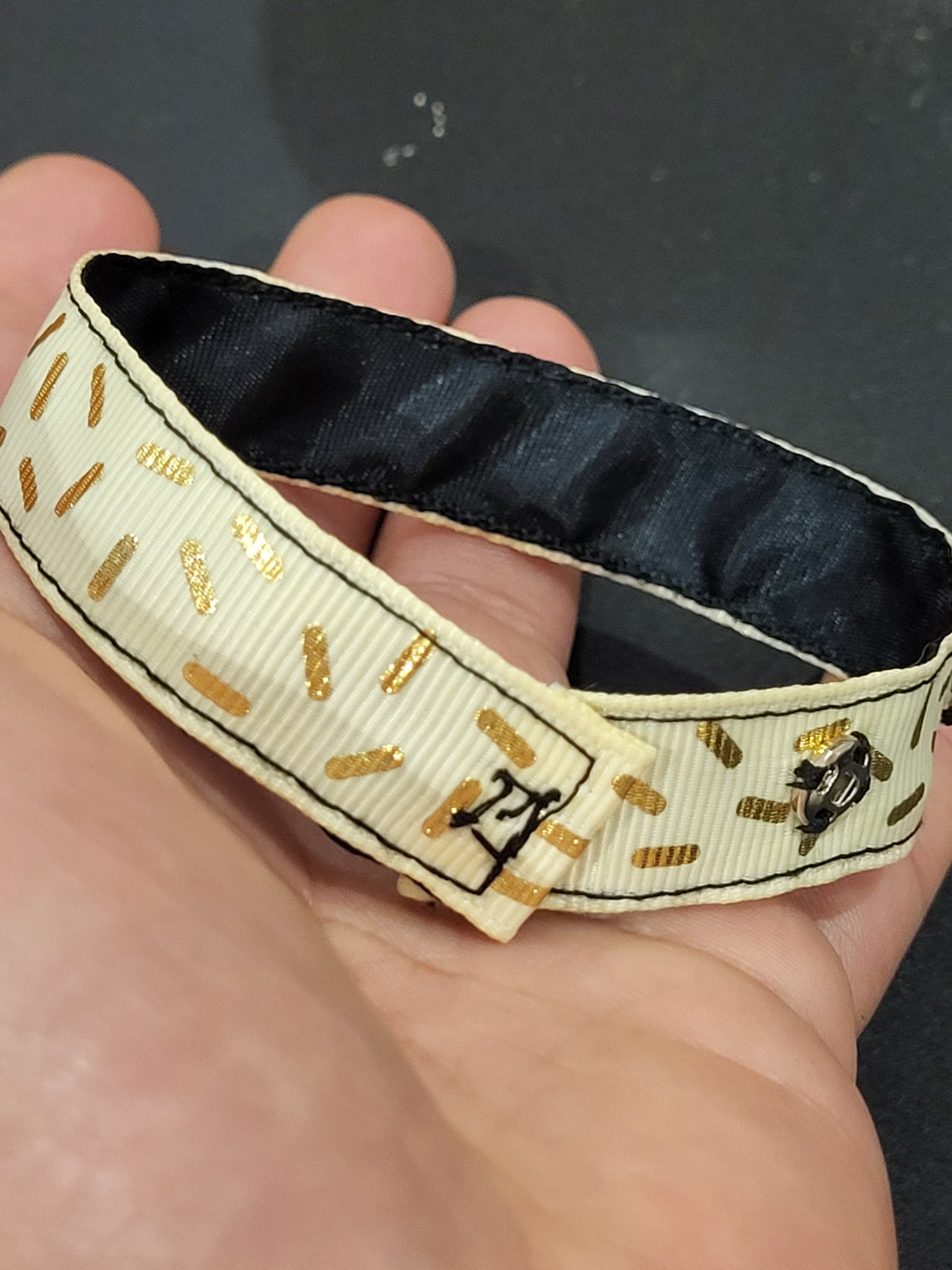 Handmade gold sprinkle fabric cuff bracelet with black ribbon backing