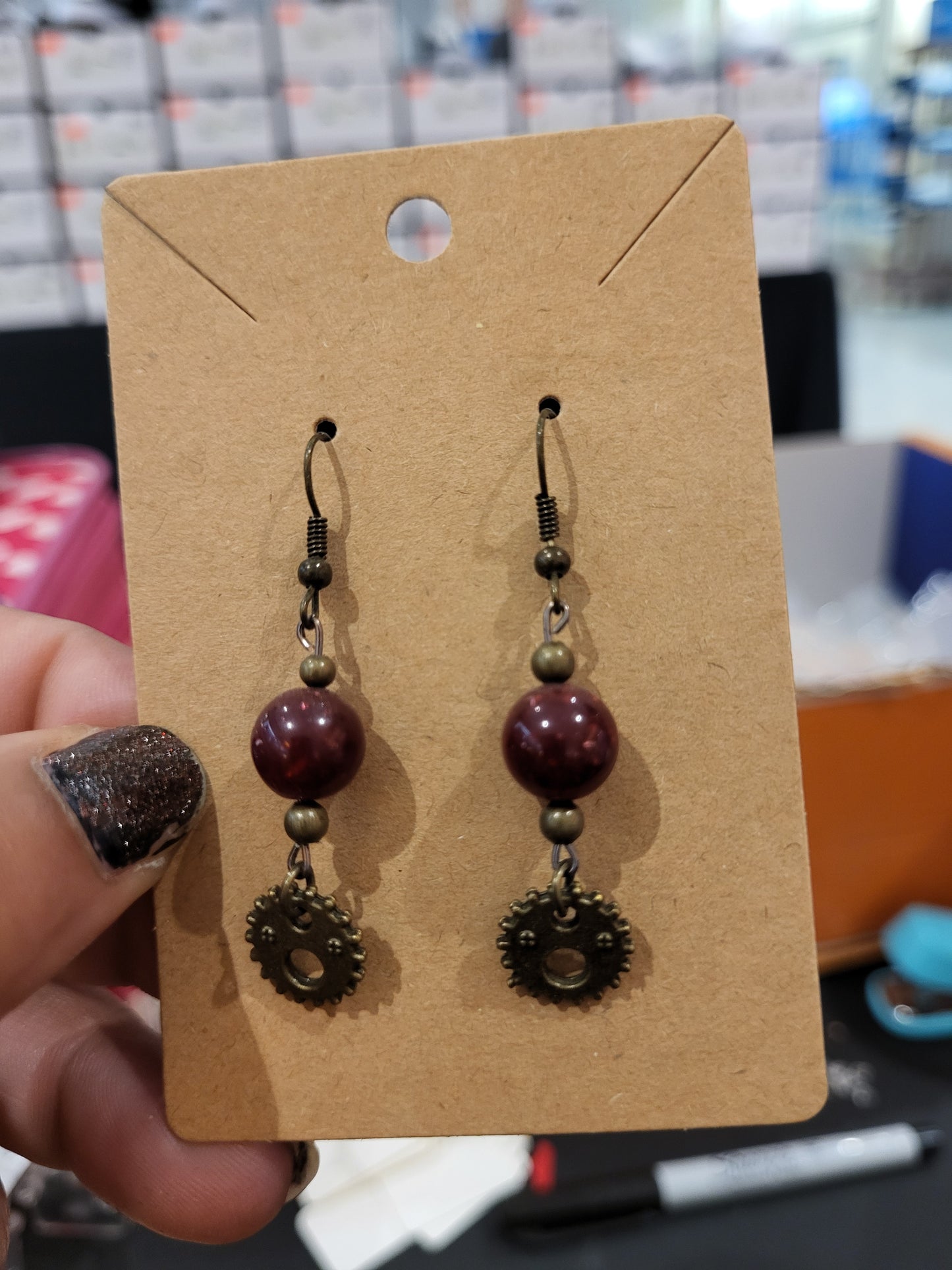 Handmade red bead and small face gear earrings