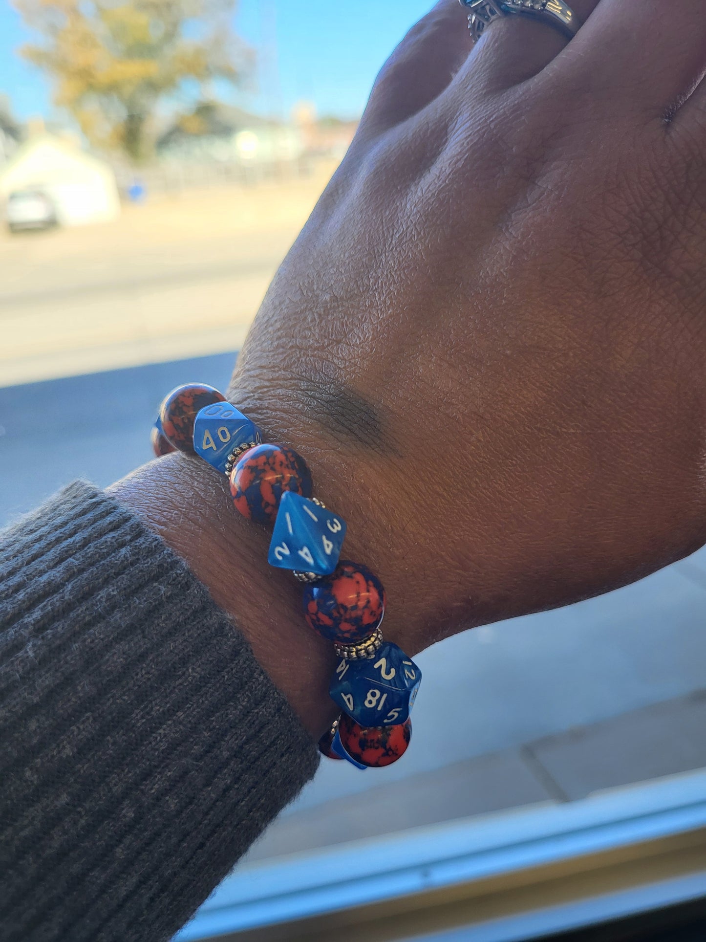 Orange and blue splotchy bead and blue dice stretch bracelet